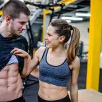 woman smiling at man's abs