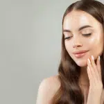 a woman touches her stunning and gorgeous face