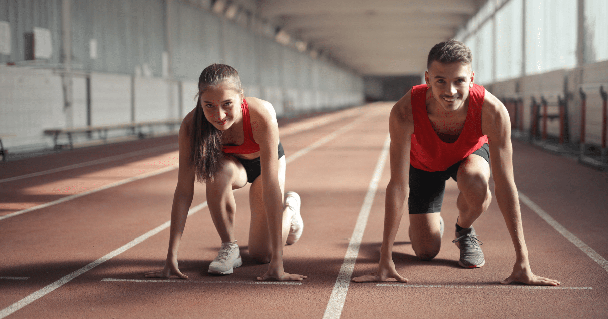 A man and a woman preparing into running posture