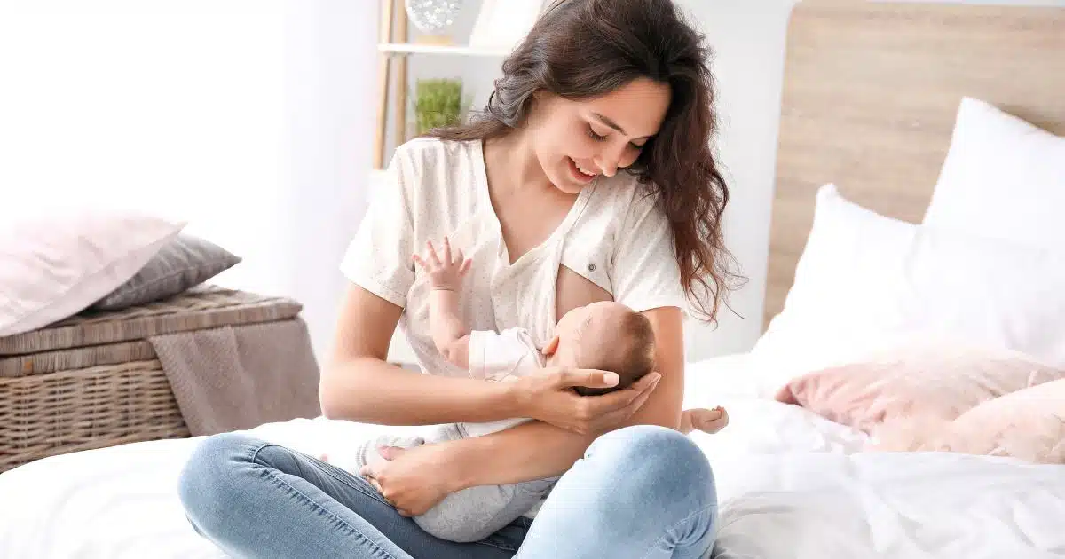 a woman holding her baby smiling