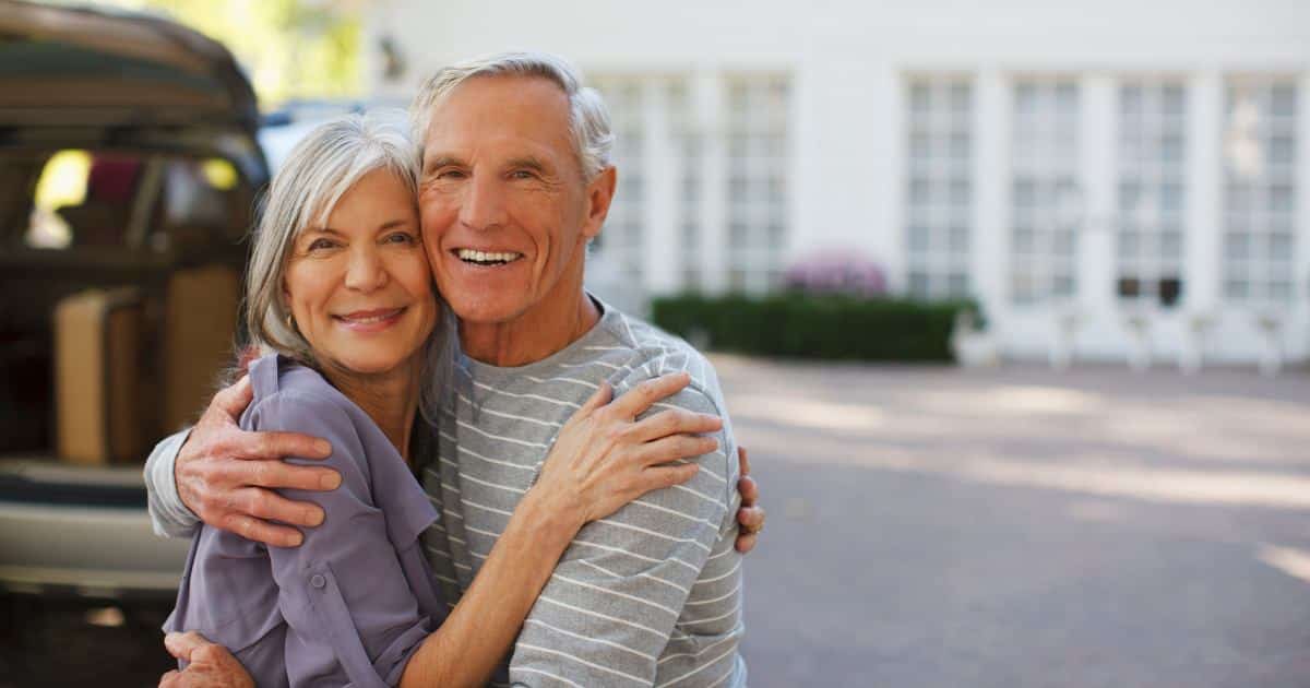 an older man and women hugging or looking happy