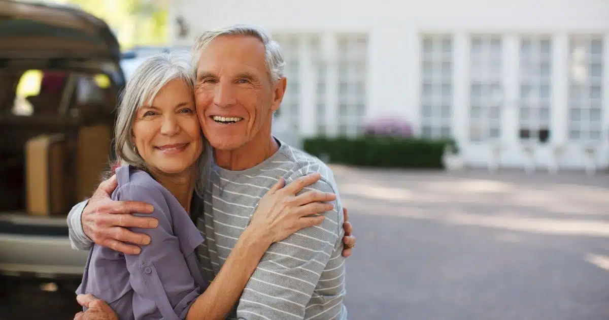 an older man and women hugging or looking happy