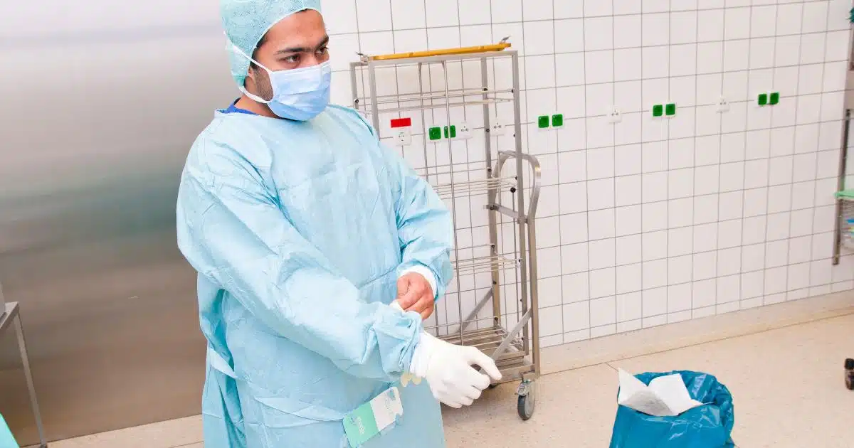 someone in a surgical gown looking worried